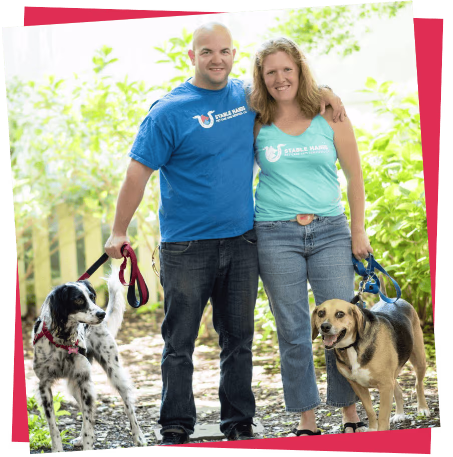 Stable Hands Pet Care owners standing with two dogs after a dog walk in Virginia Beach